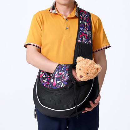 A person using the pet sling to carry a plush toy to demonstrate the bag's functionality