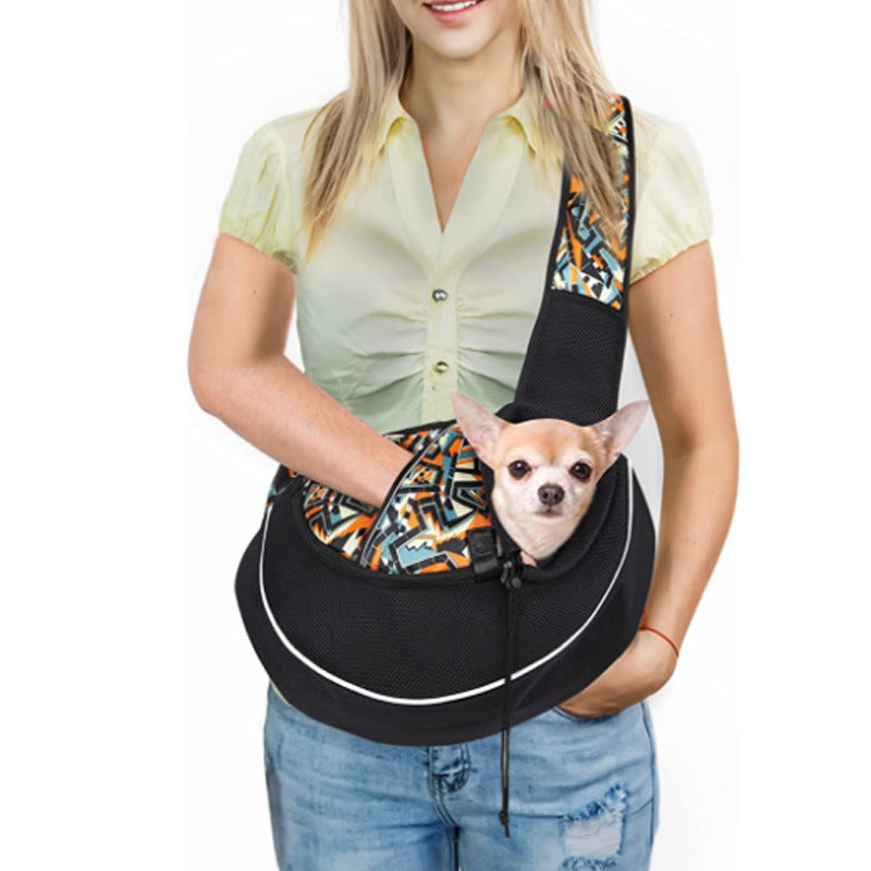 A close-up of a small dog comfortably seated in a crossbody pet carrier